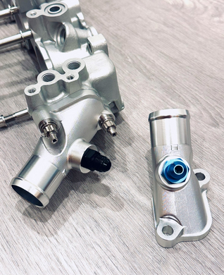 Supertec Racing billet water outlet for the Nissan RB26 engine. Machined from billet 6082 aluminium with auxiliary port and supplied with AN6-9/16 fitting or 3/8 barb or blank plug (turbo water return) or blank plugged for use with turbos that are not water cooled. 

